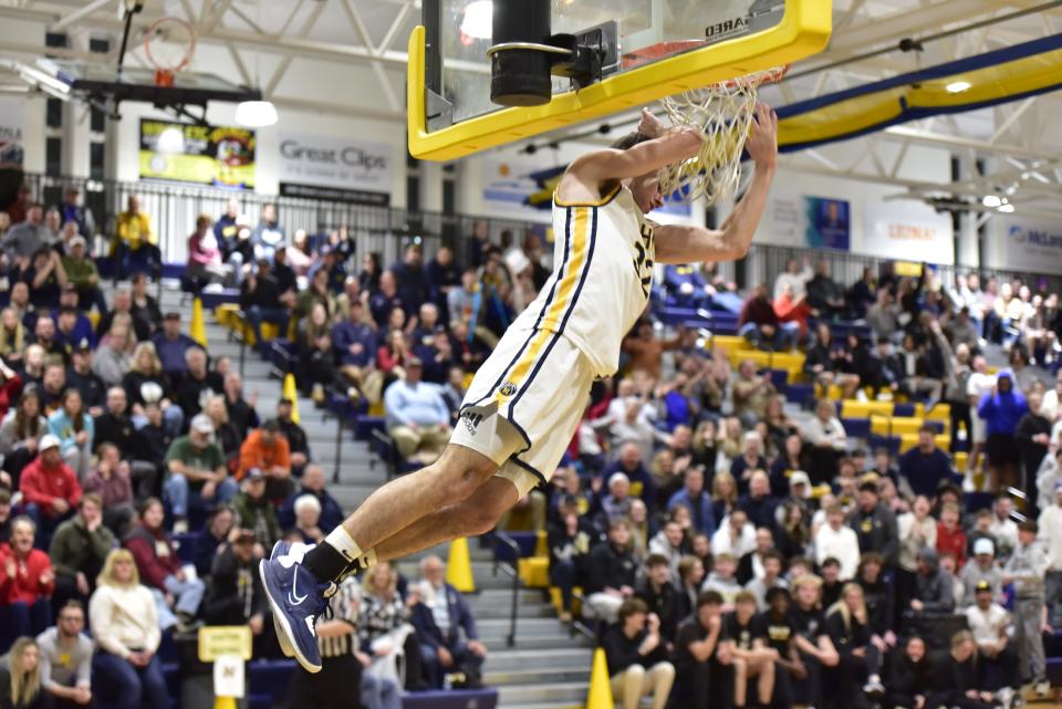 Port Huron Northern's Tyler Jamison finishes a slam dunk during the Huskies' 75-62 win over Macomb L'Anse Creuse North in a Division 1 district semifinal at Port Huron Northern High School on Wednesday, March 8, 2023.