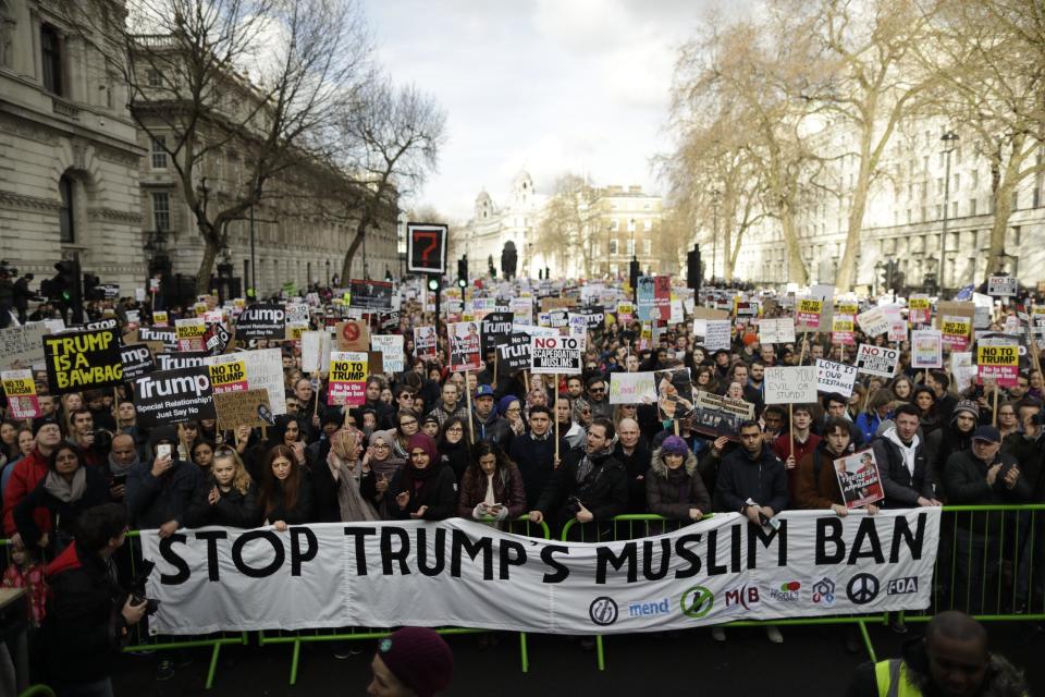 People listen to speakers during a rally at the end of a protest match on Whitehall in London, against U.S. President Donald Trump's ban on travellers and immigrants from seven predominantly Muslim countries entering the U.S., Saturday, Feb. 4, 2017. (AP Photo/Matt Dunham)