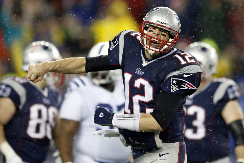 New England Patriots quarterback Tom Brady celebrates a touchdown by New England Patriots running back LeGarrette Blount during the first half of an AFC divisional NFL playoff football game against the Indianapolis Colts in Foxborough, Mass., Saturday, Jan. 11, 2014. (AP Photo/Michael Dwyer)