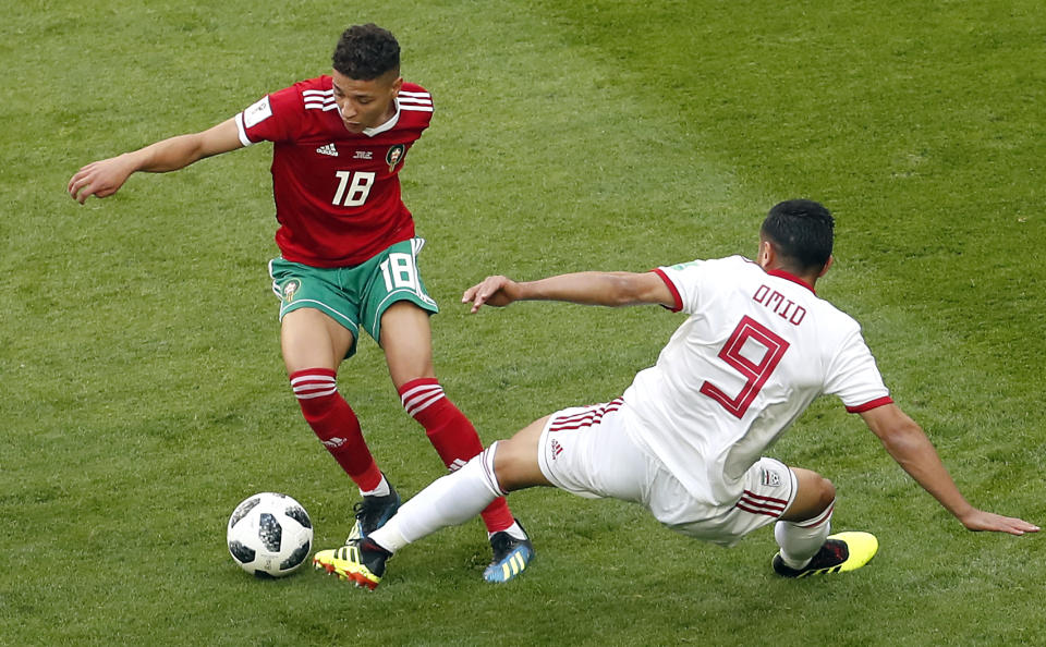 <p>Morocco’s Amine Harit, left, and Iran’s Omid Ebrahimi, right, challenge for the ball. (AP) </p>