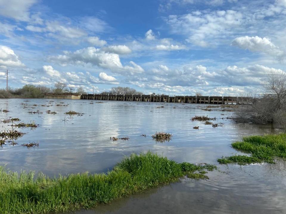 The San Joaquin River, mixed with water from the Fresno Slough and Delta-Mendota Canal, flows above 104-year-old Mendota Dam on March 20, 2023. Flow rates in this area were measured at 4,000 cubic feet per second.