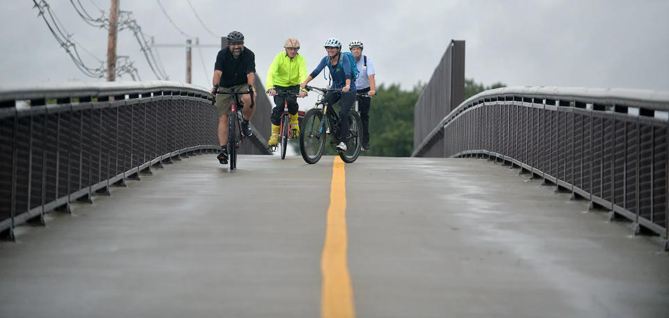 From left, Joel Barrera, William Hanson, Alexi Conine and Peter Sutton take a spin on the newly opened Framingham-Natick Rail Trail in September 2021.