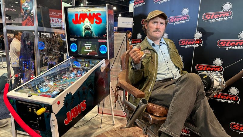 Jaws Pinball Machine next to a mannequin dressed like a Jaws character. 