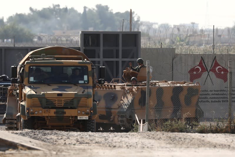 Turkish soldiers in military vehicles return from the Syrian town of Tal Abyad, as they are pictured on the Turkish-Syrian border in Akcakale