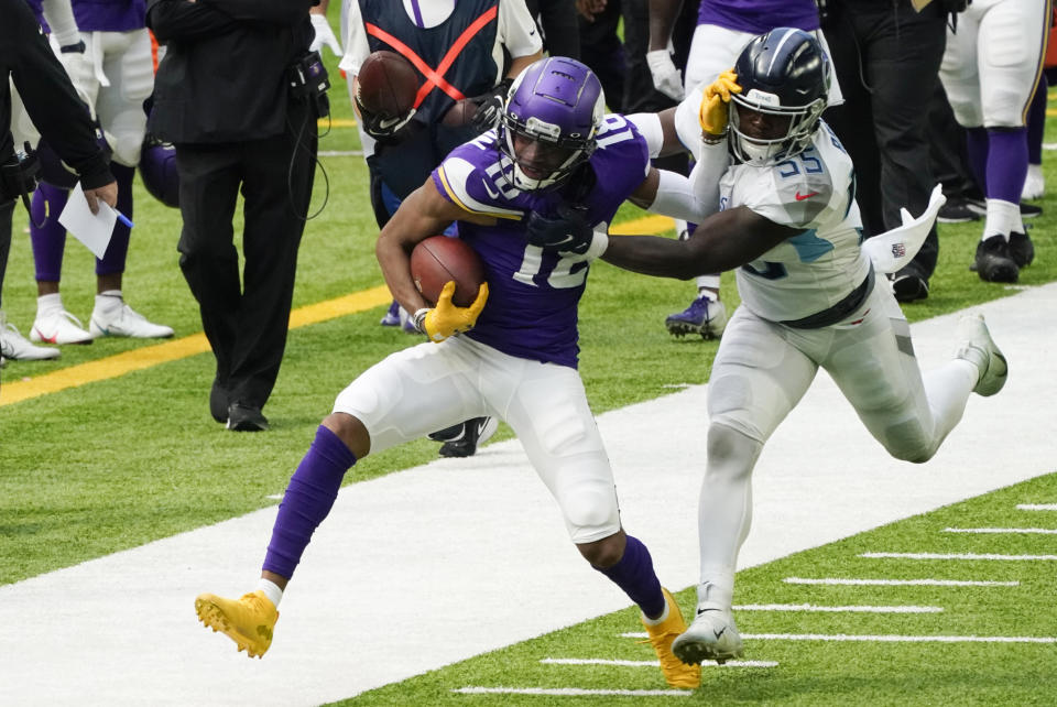 Minnesota Vikings wide receiver Justin Jefferson (18) tries to break a tackle by Tennessee Titans inside linebacker Jayon Brown, right, during the first half of an NFL football game, Sunday, Sept. 27, 2020, in Minneapolis. (AP Photo/Jim Mone)