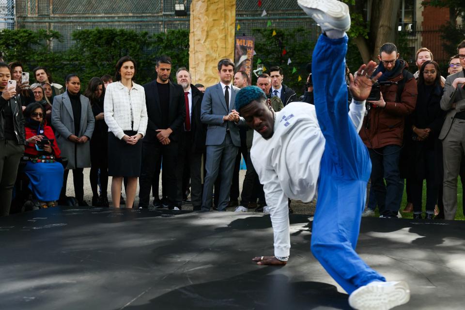  Danis Civil aka France's B-boy Dany Dann performs in front of France's Minister for Sports and Olympics Amelie Oudea-Castera (C-2L), French President of the Paris 2024 Olympics and Paralympics Organising Committee (Cojo) Tony Estanguet (C-L) and French Prime Minister Gabriel Attal (C) during the Olympics Flag Tour at the Hotel de Matignon in Paris on April 25, 2024. 