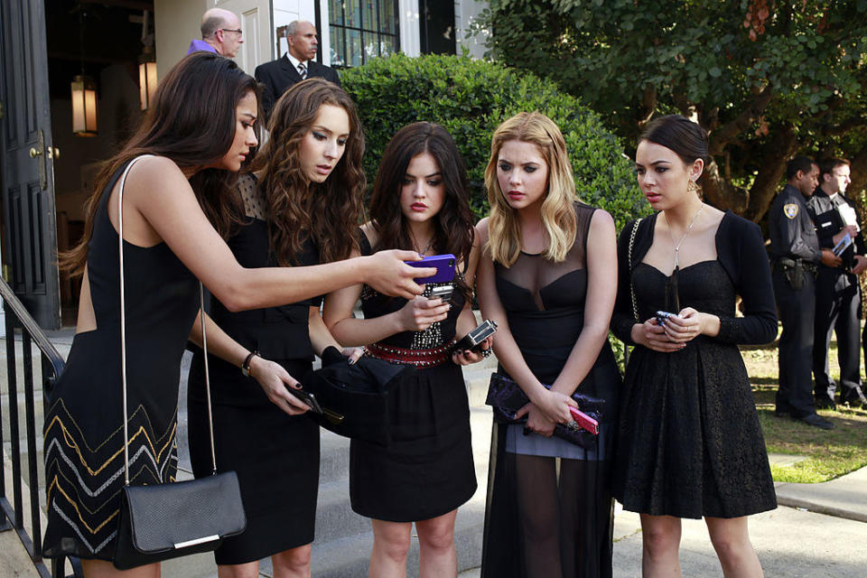 Janel with Shay Mitchell and Troian Bellisario and Lucy Hale and Ashley Benson on "Pretty Little Liars" all looking at a phone