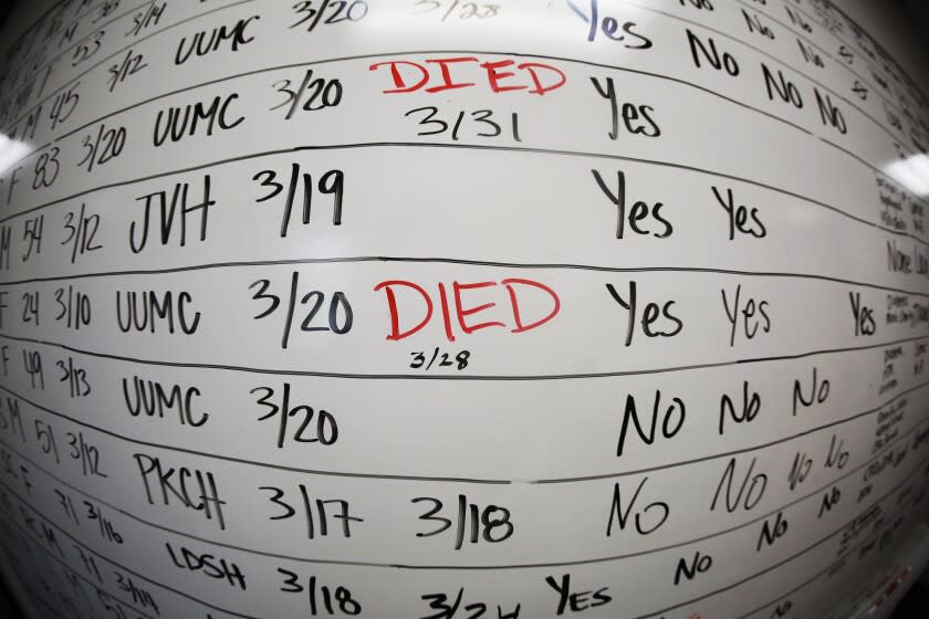 FILE - This May 13, 2020 photo made with a fisheye lens shows a list of the confirmed COVID-19 cases in Salt Lake County early in the coronavirus pandemic at the Salt Lake County Health Department, in Salt Lake City. Health officials later moved to tracking the cases in an online database, but the white board remains in the office as a reminder of how quickly the coronavirus spread. (AP Photo/Rick Bowmer)