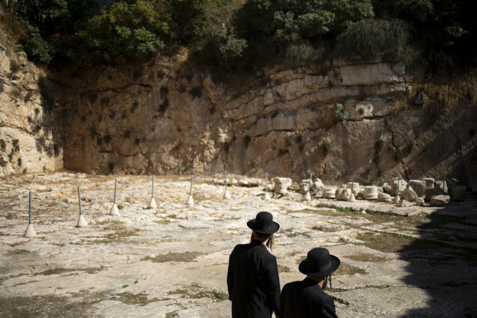 In this Thursday, Oct. 31, 2019 photo, ultra-Orthodox Jews visit the Tomb of the Kings, a large underground burial complex dating to the first century BC, in east Jerusalem neighborhood of Sheikh Jarrah. After several aborted attempts, the French Consulate General has reopened one of Jerusalem's most magnificent ancient tombs to the public for the first time in over a decade, sparking a distinctly Jerusalem conflict over access to an archaeological-cum-holy site in the volatile city's eastern half. (AP Photo/Ariel Schalit)