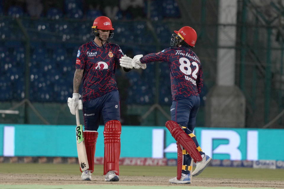 Islamabad United' Alex Hales, left, celebrates with Colin Munro after playing a shot for boundary during the Pakistan Super League T20 cricket match between Karachi Kings and Islamabad United, in Karachi, Pakistan, Wednesday, Feb. 28, 2024. (AP Photo/Fareed Khan)