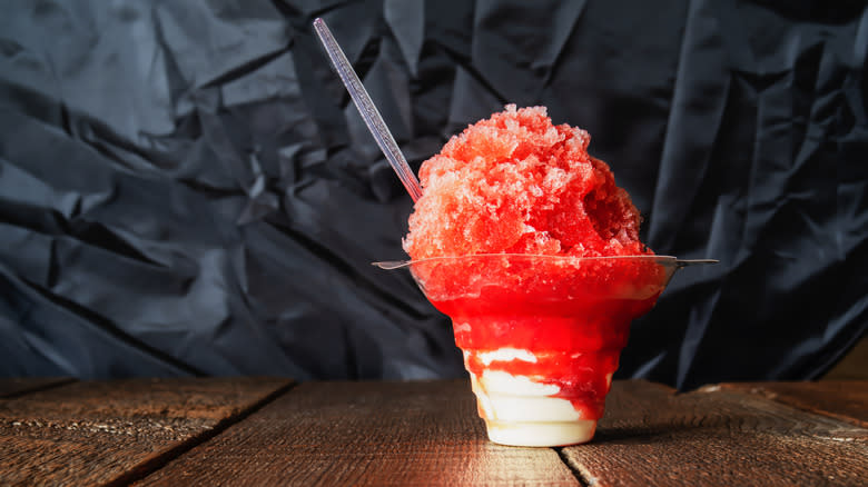 plastic cup of red shaved ice with straw