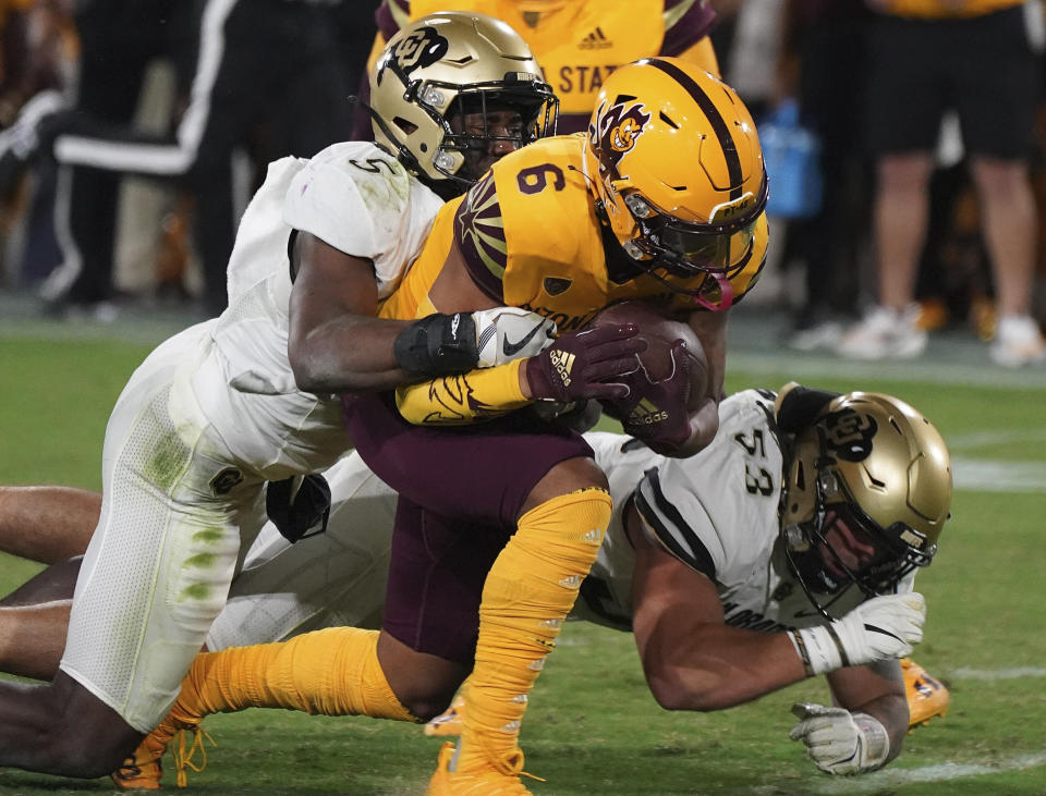Arizona State wide receiver LV Bunkley-Shelton (6) is brought down by Colorado safety Mark Perry (5) and linebacker Nate Landman during the second half of an NCAA college football game Saturday, Sept. 25, 2021, in Tempe, Ariz. (AP Photo/Darryl Webb)