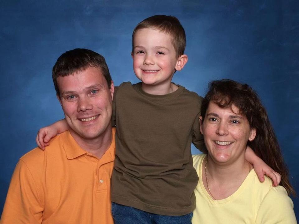 Timmothy Pitzen, center, with parents Jim and Amy Pitzen