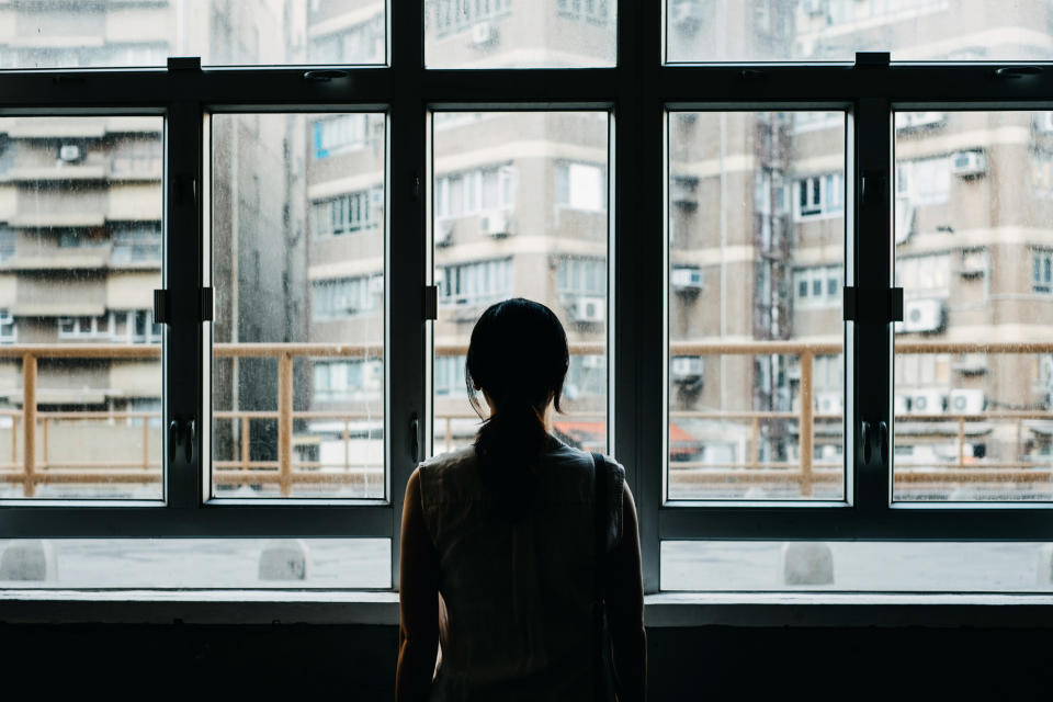 A person staring out a window