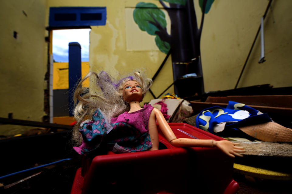 FILE - A discarded Barbie doll lays in a classroom of an abandoned school, one of the many buildings and homes left behind because of the threat of ground subsidence caused by the Braskem mine, in the Pinheiro neighborhood of Maceio, Alagoas state, Brazil, March 6, 2022. A Brazilian petrochemical company said Friday, July 21, 2023 that it had reached a $355 million settlement with the coastal city where four decades of Braskem's rock salt mining destroyed five urban neighborhoods and displaced tens of thousands of people. (AP Photo/Eraldo Peres, File)