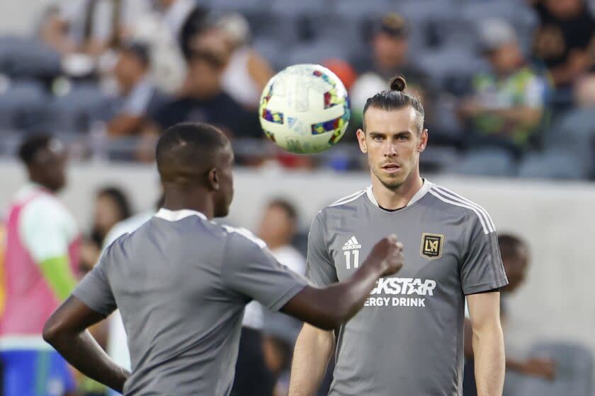Los Angeles FC forward Gareth Bale (11) and defender Franco Escobar (2) warm up prior to an MLS soccer match against the Seattle Sounders Friday, July 29, 2022, in Los Angeles. (AP Photo/Ringo H.W. Chiu)