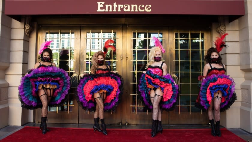 Mask-wearing cancan dancers welcomed visitors to Paris Las Vegas during an opening celebration June 18. <span class="copyright">(Caesars Entertainment)</span>