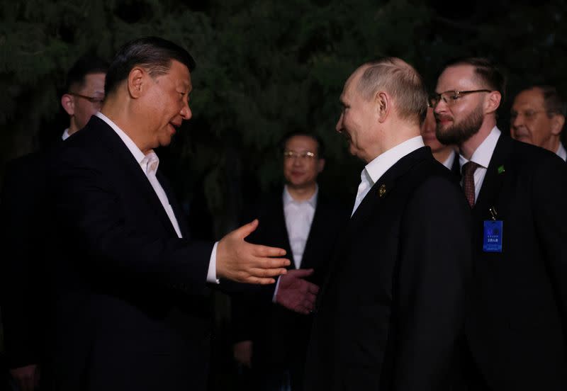 Russian President Vladimir Putin and Chinese President Xi Jinping bid farewell at the end of talks in Beijing