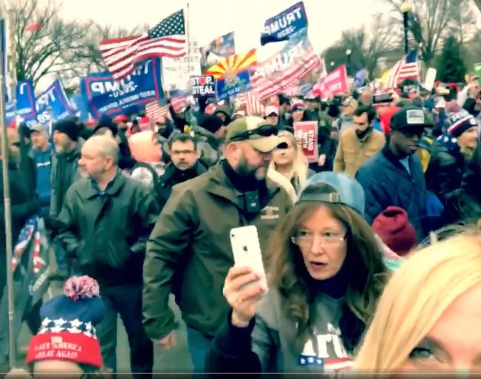 Sandra Atkinson marches through Washington, D.C., Jan. 6, 2021, in an image taken from video by Sherri Edwards Cox. A woman in the same clothing later appeared on surveillance video from inside the storming of the Capitol.