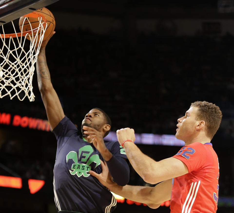 West Team's Paul George of the Indian Pacers (24) goes to the hoop as West Team's Blake Griffin, of the Los Angeles Clippers (32) defends during the NBA All Star basketball game, Sunday, Feb. 16, 2014, in New Orleans. (AP Photo/Gerald Herbert)