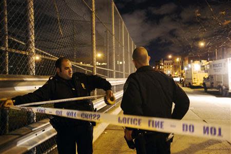 New York Police Department officers mark off the area surrounding the scene of a multiple shooting crime scene on Maujer Street in the Brooklyn borough of New York, November 11, 2013. REUTERS/Lucas Jackson