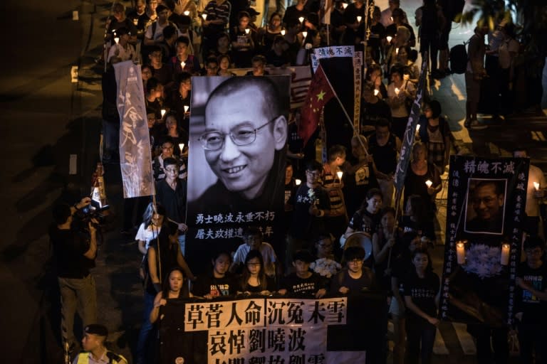 Thousands took to the streets of central Hong Kong Saturday night holding candles as they marched in memory of pro-democracy Chinese dissident Liu Xiaobo