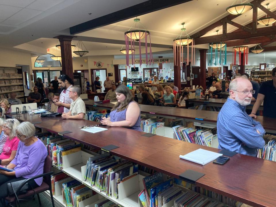 Ottawa County residents wait for a library board meeting to start at Jamestown Township's Patmos Library Monday, Aug. 8, 2022.