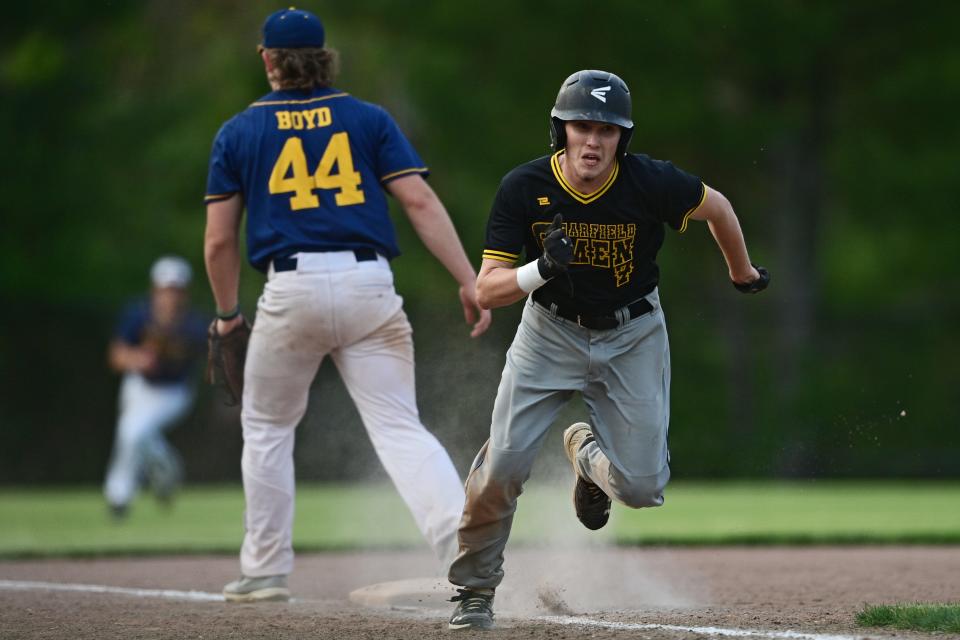 Garfield's Ian Hunt runs home to score a run during the second inning of an OHSAA district semifinal Monday night at Cene Park in Struthers.