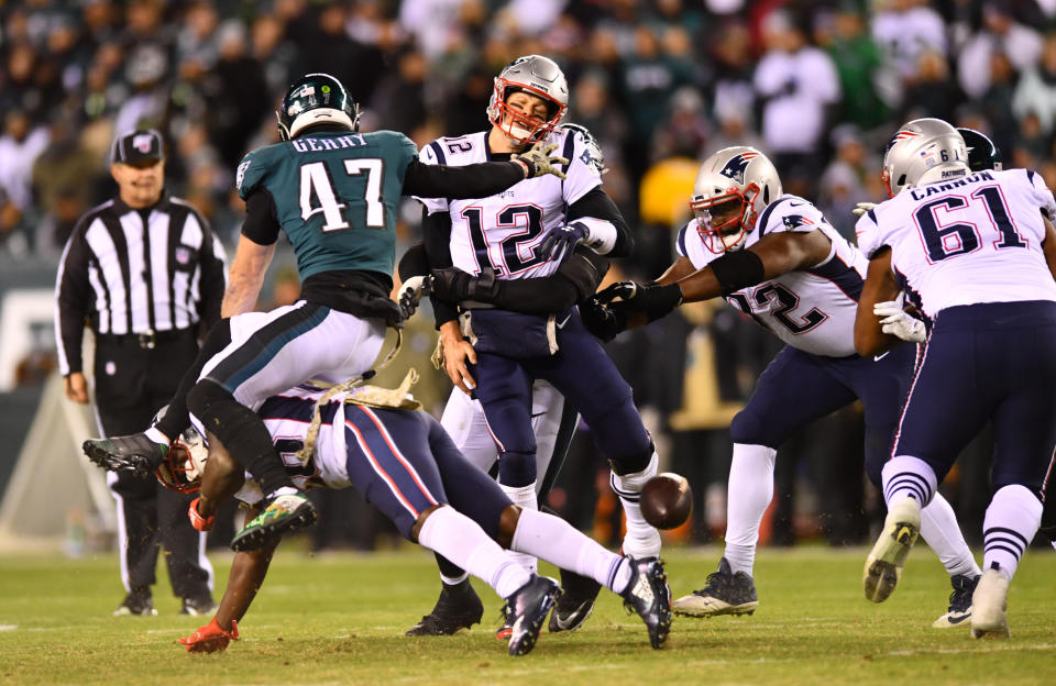 New England Patriots quarterback Tom Brady (12) is hit after spiking the ball under pressure against the Eagles. (Photo by Kyle Ross/Icon Sportswire via Getty Images)