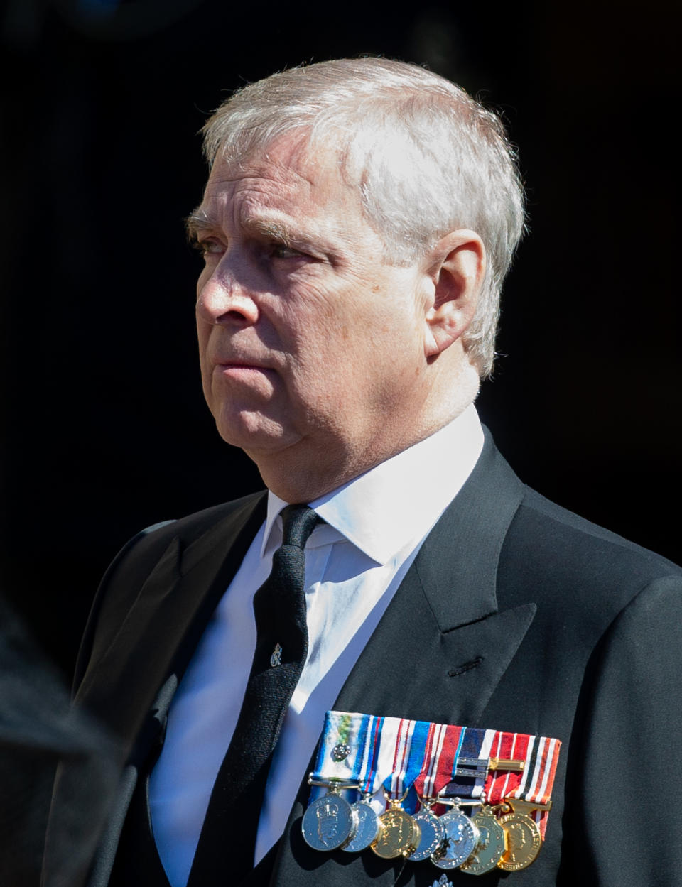 WINDSOR, ENGLAND - APRIL 17: Prince Andrew, Duke of York looks on as the coffin of Prince Philip, Duke of Edinburgh arrives St George's Chapel in a purpose build Land Rover during the funeral of Prince Philip, Duke of Edinburgh on April 17, 2021 in Windsor, England. Prince Philip of Greece and Denmark was born 10 June 1921, in Greece. He served in the British Royal Navy and fought in WWII. He married the then Princess Elizabeth on 20 November 1947 and was created Duke of Edinburgh, Earl of Merioneth, and Baron Greenwich by King VI. He served as Prince Consort to Queen Elizabeth II until his death on April 9 2021, months short of his 100th birthday. His funeral takes place today at Windsor Castle with only 30 guests invited due to Coronavirus pandemic restrictions. (Photo by Pool/Samir Hussein/WireImage)