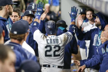Sep 21, 2017; Seattle, WA, USA; Seattle Mariners second baseman Robinson Cano (22) celebrates in the dugout after hitting a solo home run against the Texas Rangers during the ninth inning at Safeco Field. The hit was the 300th career home run by Cano. Mandatory Credit: Joe Nicholson-USA TODAY Sports