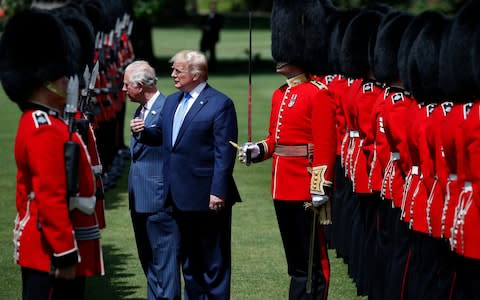 President Donald Trump inspect the Guard of Honour at Buckingham Palace - Credit: Alex Brandon/AP