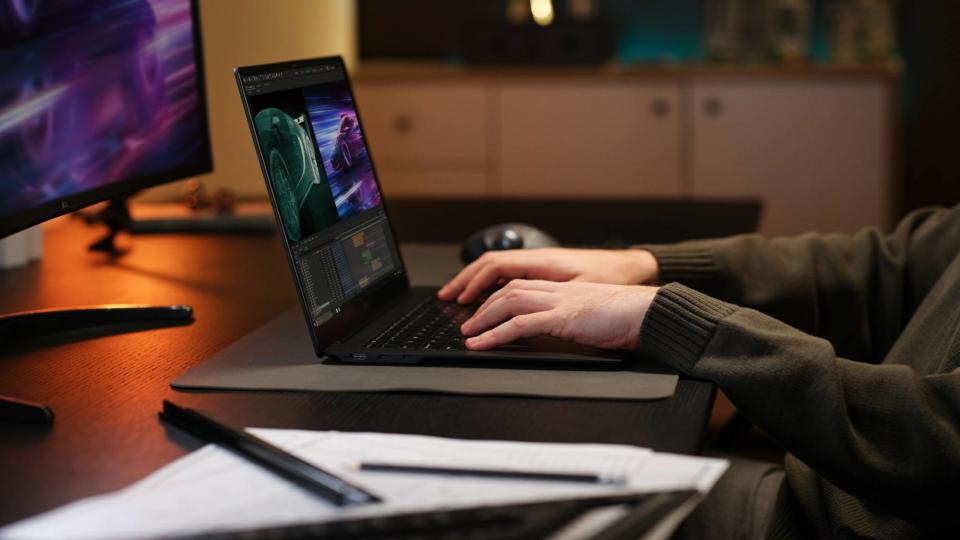 Man typing on LG Gram Pro at a table