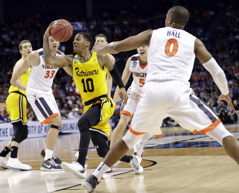 UMBC’s Jairus Lyles (10) drives past Virginia’s Devon Hall (0) during the second half of a first-round game in the NCAA men’s college basketball tournament in Charlotte, N.C., Friday, March 16, 2018. (AP Photo/Gerry Broome)