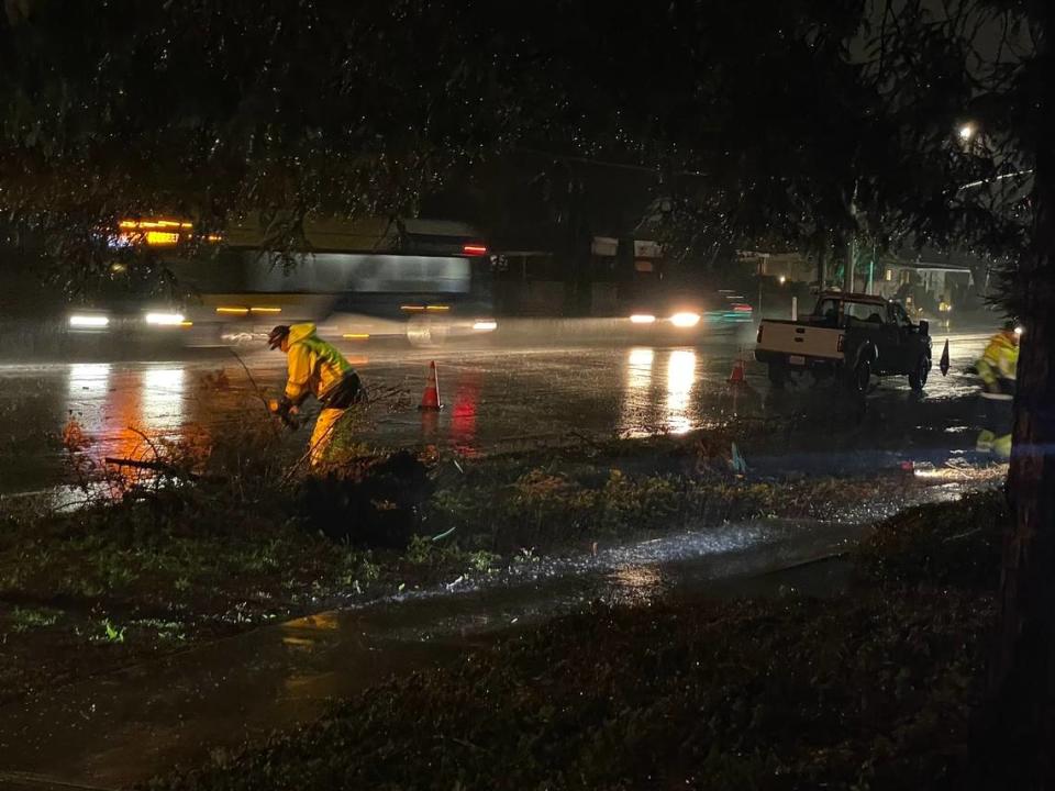 Crews work to remove tree branches that fell on South Higuera Street in San Luis Obispo during a storm March 29, 2024.