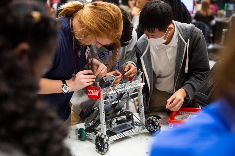 Students work on their robots in a robotics competition at LAMP High School.