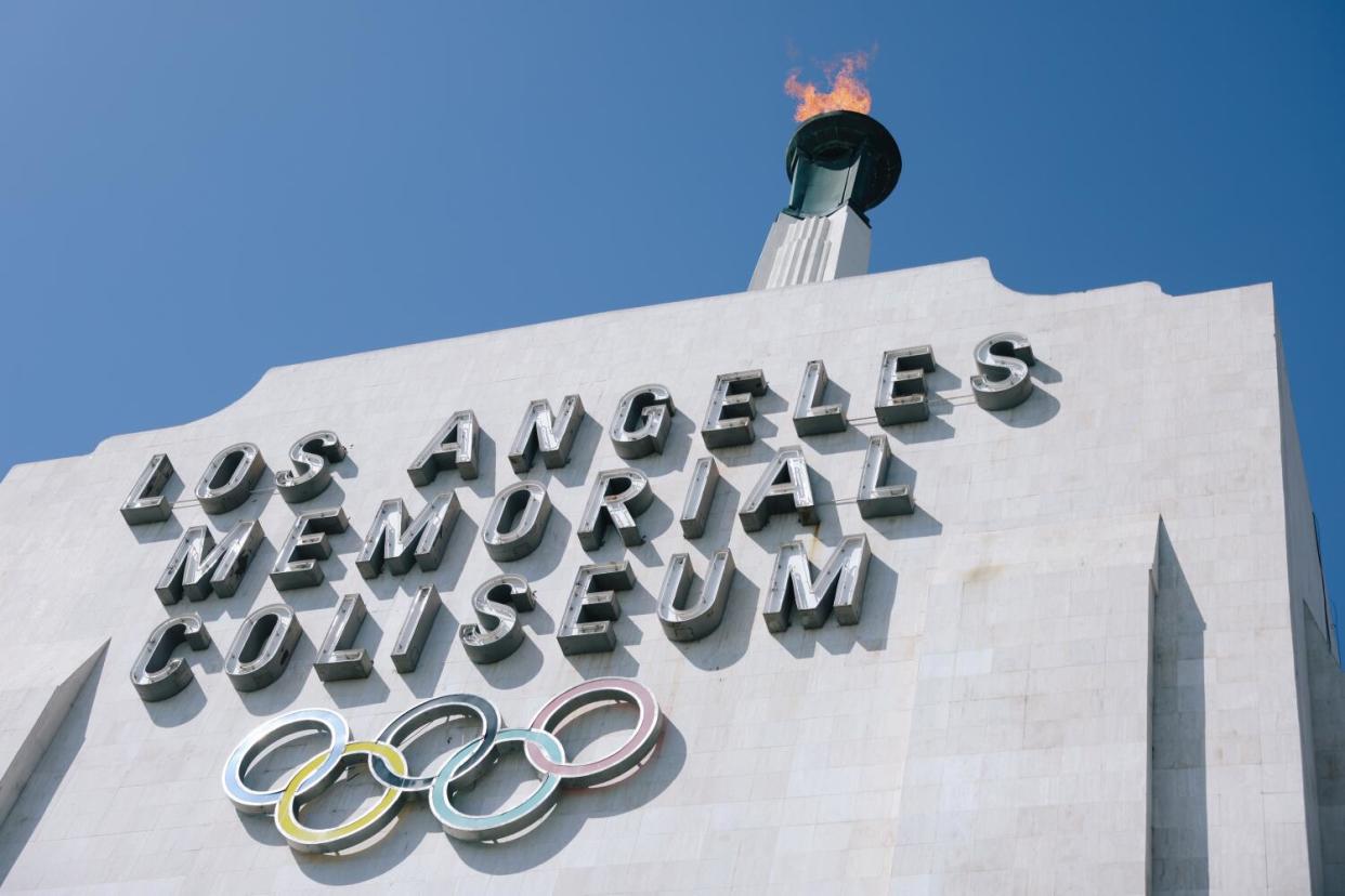 The torch is lit at the Los Angeles Memorial Coliseum, a venue set to host 2028 Olympic events.