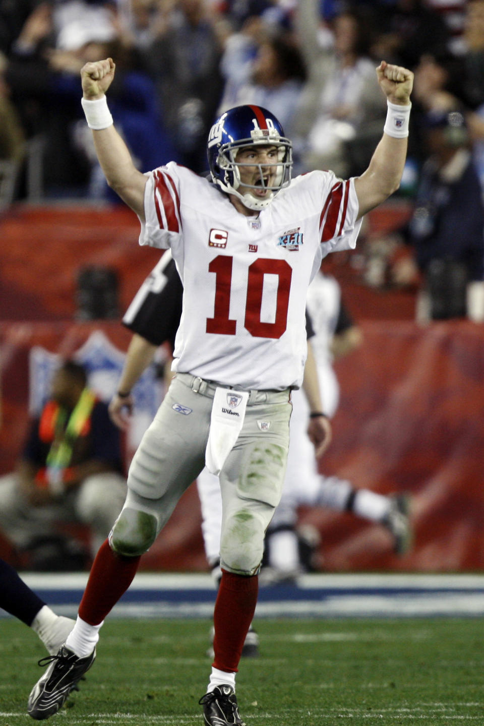 FILE - In this Feb. 3, 2008, file photo, New York Giants quarterback Eli Manning (10) celebrates after his 13-yard touchdown pass to Plaxico Burress in the fourth quarter of the Super Bowl XLII football game against the New England Patriots at University of Phoenix Stadium in Glendale, Ariz. Eli Manning's long and distinguished reign as the New York Giants' starting quarterback is seemingly over. Let the Daniel Jones era begin. Coach Pat Shurmur announced Tuesday, Sept. 17, 2019, that the No. 6 overall pick in the NFL draft is replacing two-time Super Bowl MVP as the Giants' quarterback, beginning Sunday at Tampa Bay.(AP Photo/Julie Jacobson, File)