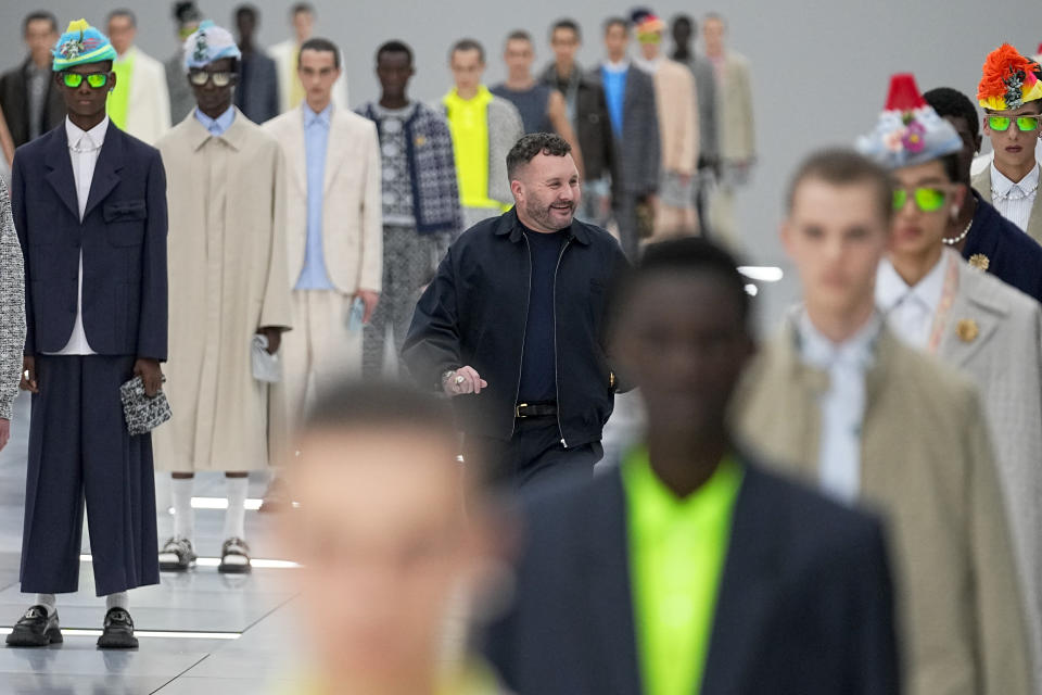 Designer Kim Jones, centre, accepts applause after the conclusion of the Dior Menswear Spring/Summer 2024 fashion collection presented in Paris, Friday, June 23, 2023. (AP Photo/Michel Euler)