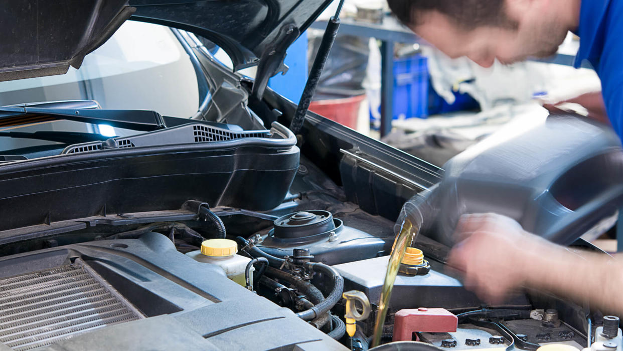 Motion blurred image of a mechanic changing oil - long exposure.