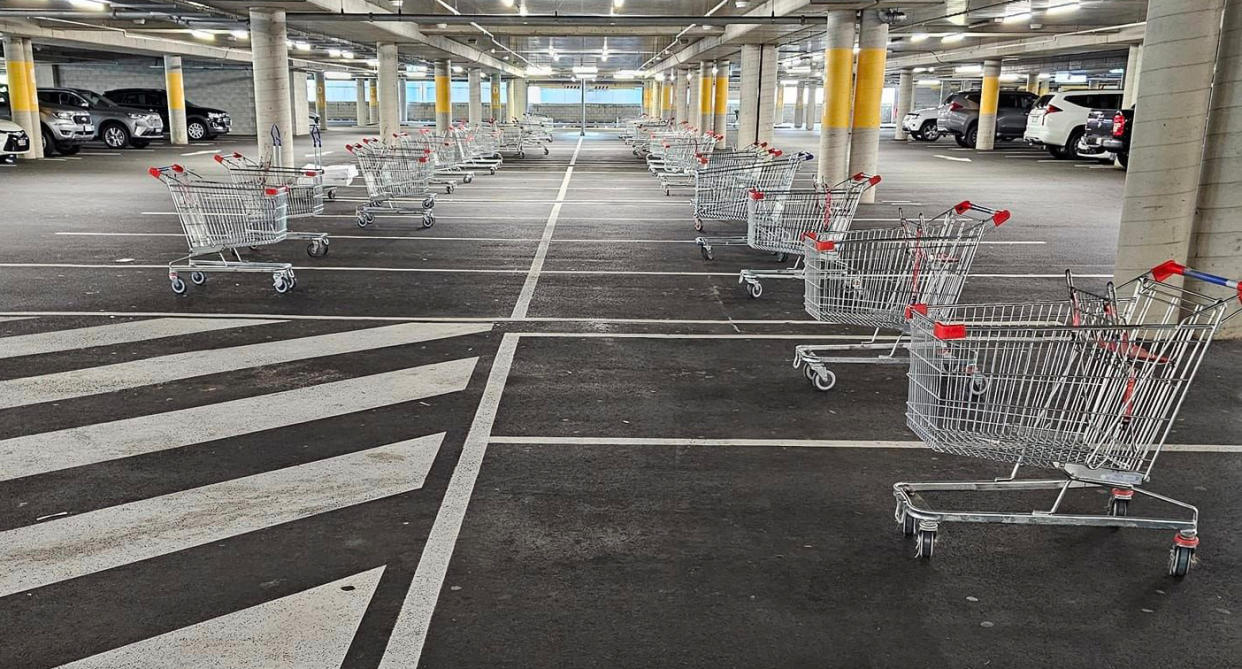 Trolleys in car spaces inside car park at Westfield North Lakes.