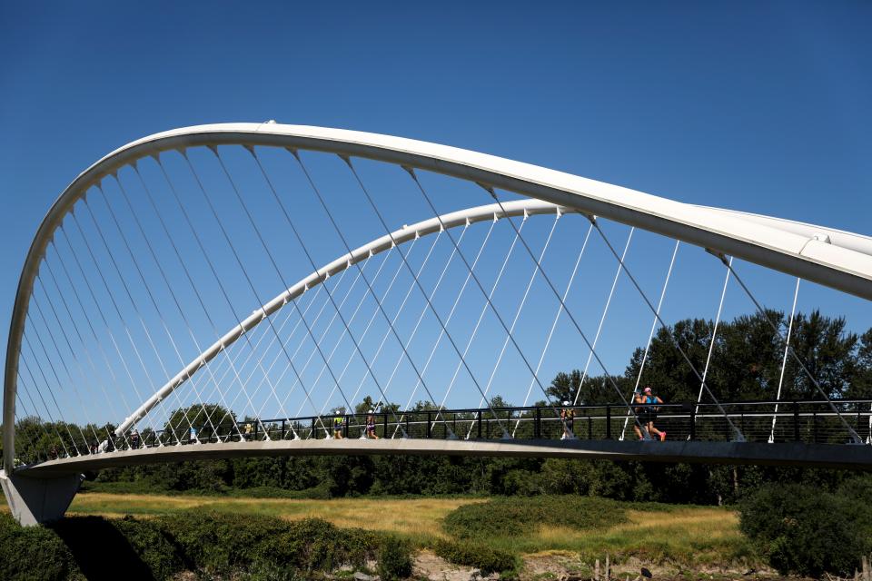 Athletes on July 23 cross the Peter Courtney Minto Island Bridge to begin their 13.1 mile run through Minto Brown Island Park during the Ironman 70.3 Oregon.