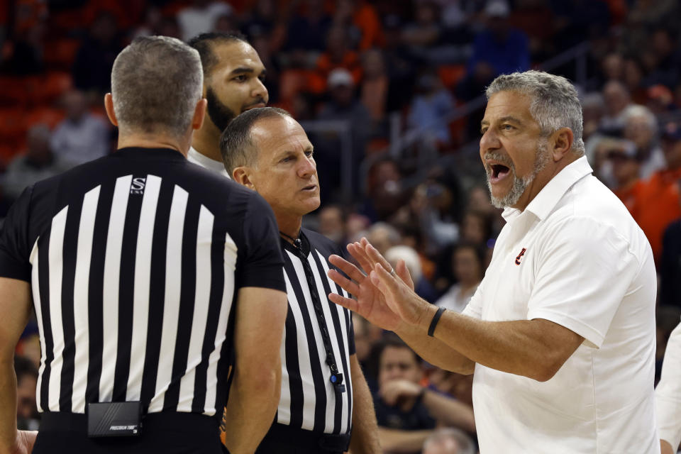 Auburn head coach Bruce Pearl, right, discusses a call with referees during the second half of an NCAA college basketball game against Saint Louis, Sunday, Nov. 27, 2022, in Auburn, Ala. (AP Photo/Butch Dill)