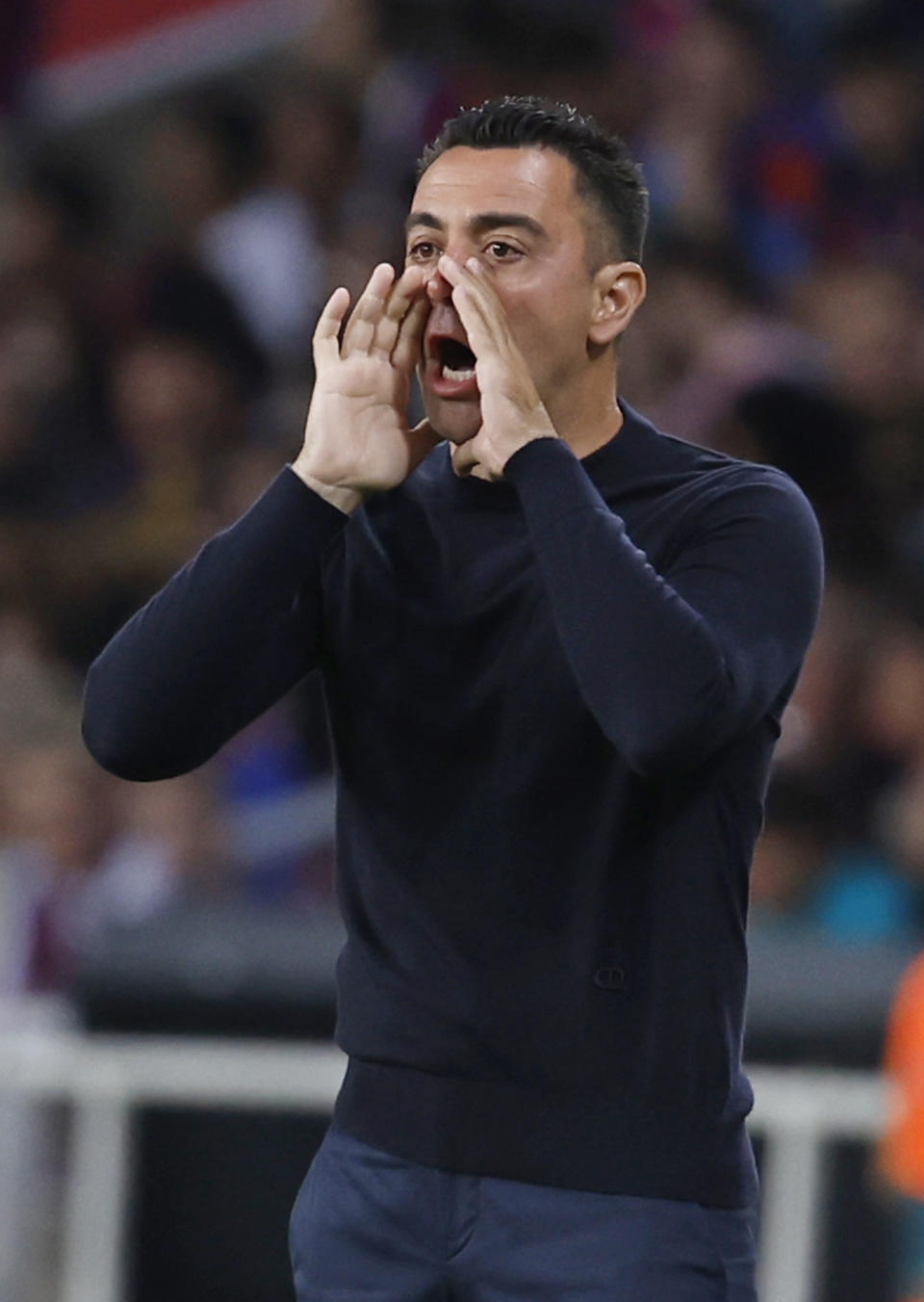 Barcelona's head coach Xavi Hernandez shouts instructions during a Spanish La Liga soccer match between Barcelona and Real Sociedad at the Olimpic Lluis Companys stadium in Barcelona, Spain, Monday, May 13, 2024. (AP Photo/Joan Monfort)