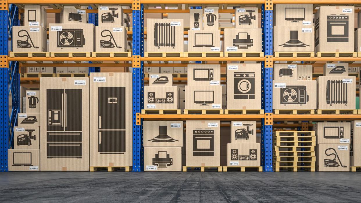 household appliances and electronic in cardboard boxes on shelves of warehouse online shopping and delivery concept