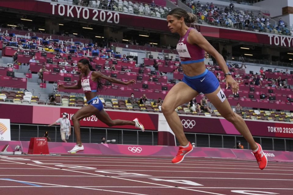 Sydney McLaughlin-Levrone, right, finishes ahead of U.S. teammate Dalilah Muhammad to win gold.