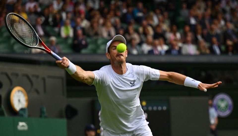 Britain's Andy Murray returns the ball to US player John Isner during their men's singles tennis match on the third day of the 2022 Wimbledon Championships  - SEBASTIEN BOZON/AFP via Getty Images