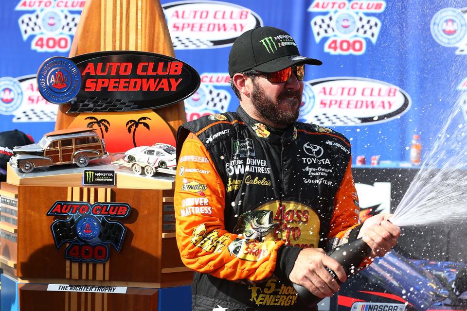 Martin Truex Jr celebrates at Auto Club Speedway in Fontana, California in 2018.