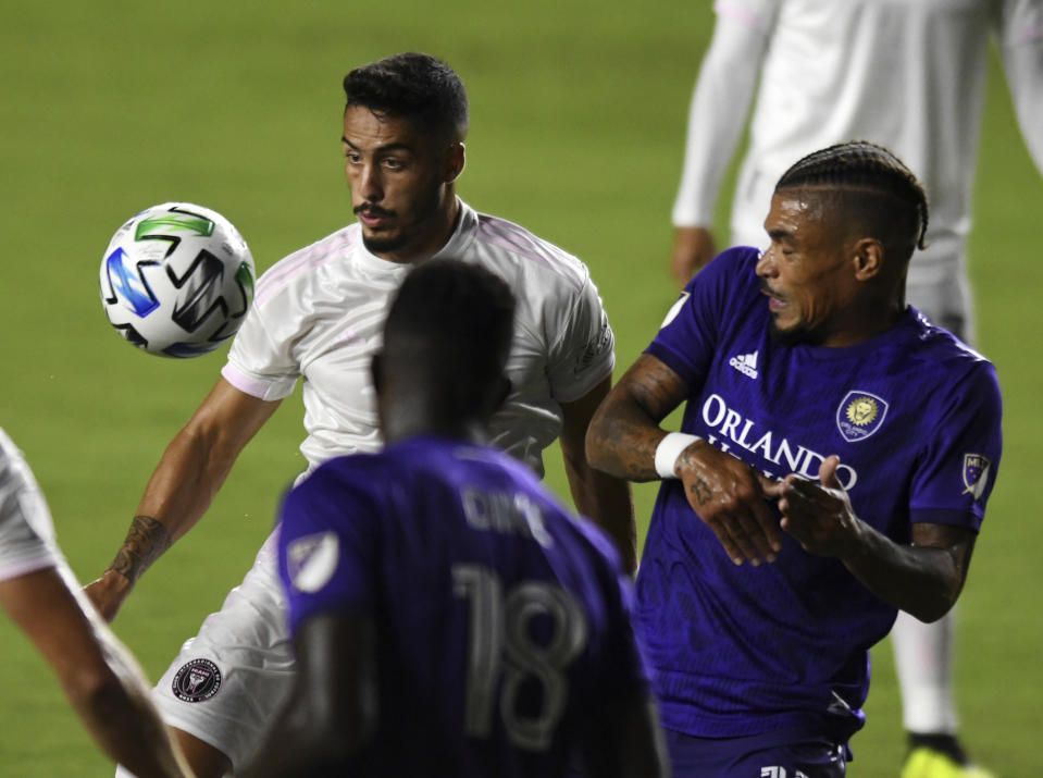 Inter Miami defender Nicolas Figal, back left, keeps his eye on the ball as Orlando City' Junior Urso, right, and Daryl Dike (18) defend on the play during the first half of an MLS soccer match Saturday, Aug. 22, 2020, in Fort Lauderdale, Fla. (AP Photo/Jim Rassol)