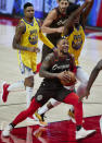 Portland Trail Blazers guard Damian Lillard drives to the basket in front of Golden State Warriors center James Wiseman, right, and forward Kent Bazemore during the second half of an NBA basketball game in Portland, Ore., Wednesday, March 3, 2021. (AP Photo/Craig Mitchelldyer)